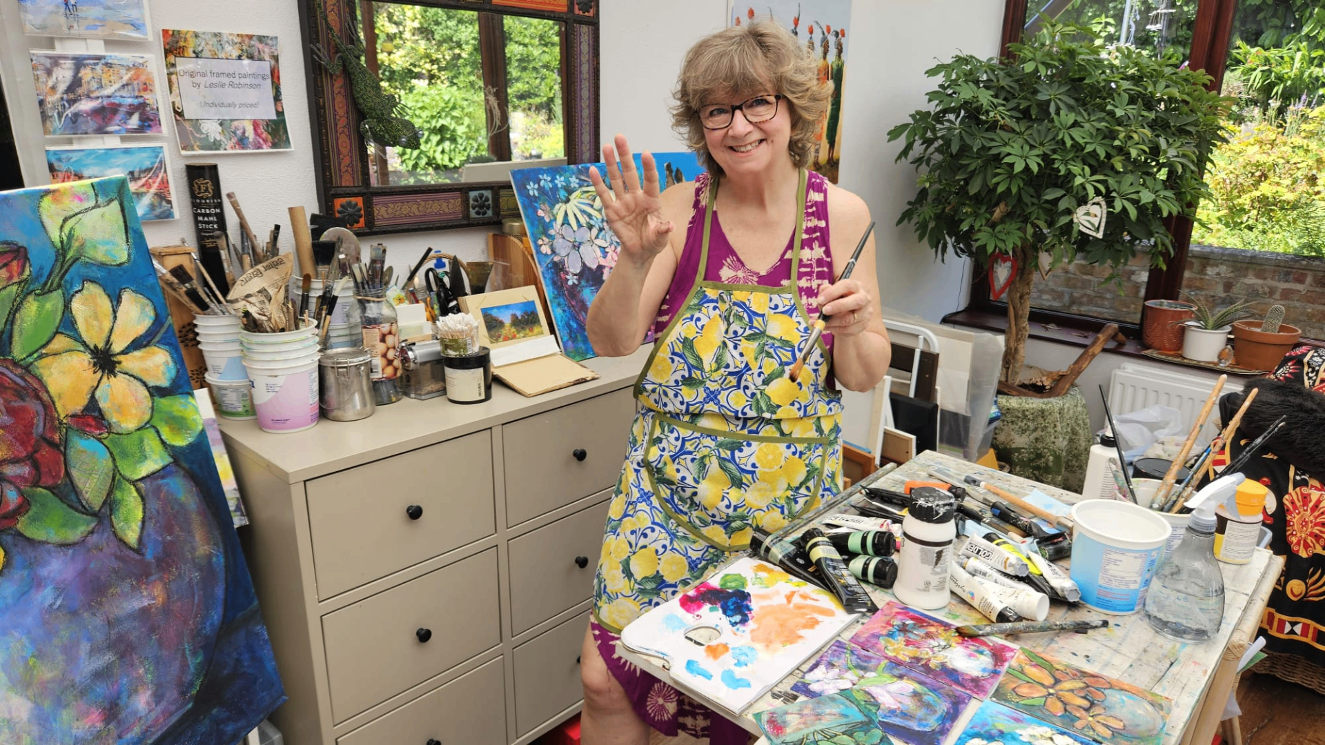 Leslie Robinson holding a brush in her studio